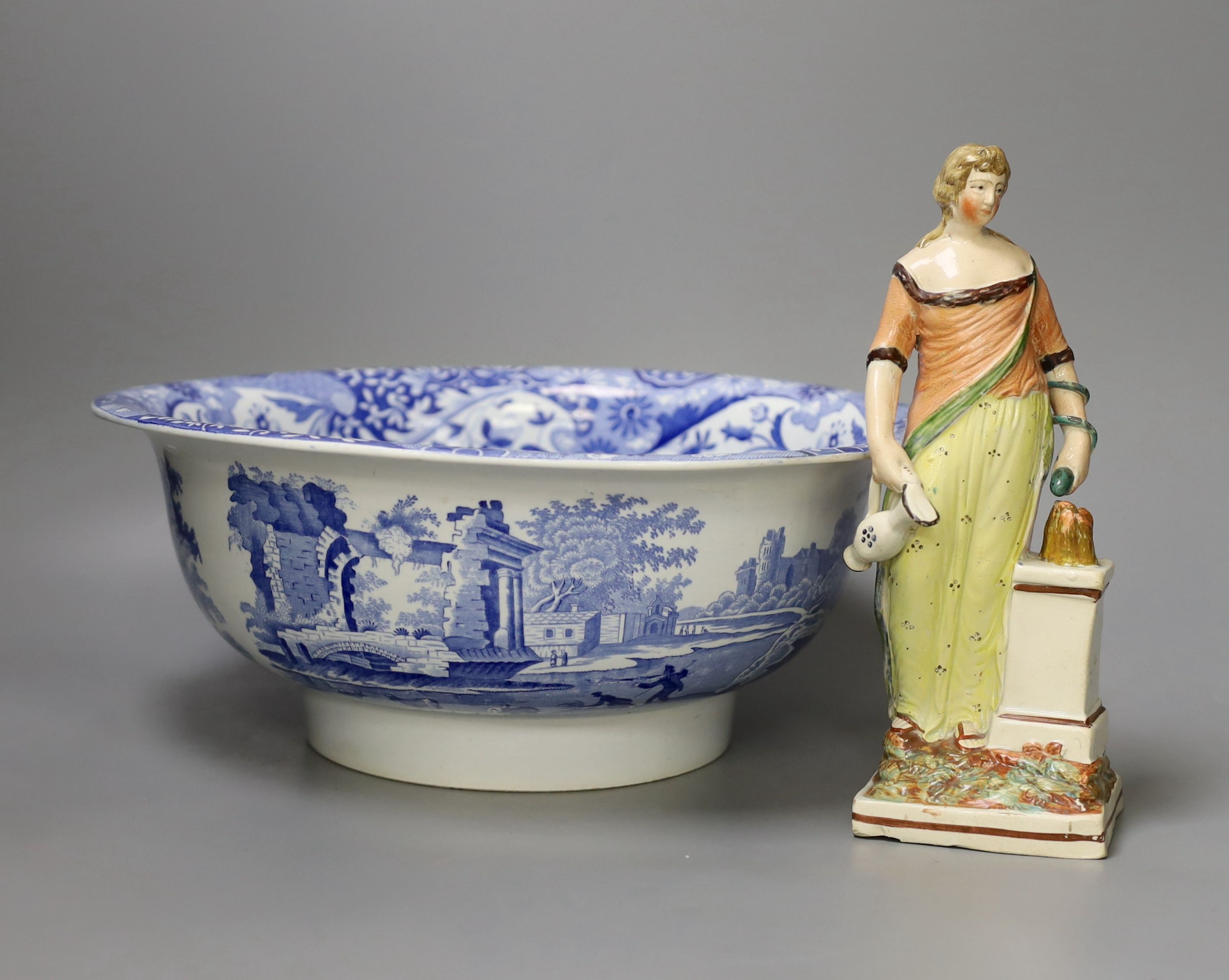 An early 19th century pearlware figure of a maiden, 24cm tall, and a Spode Italian bowl